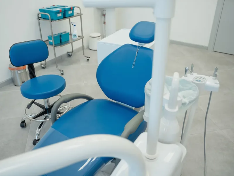 Clean dental treatment chair and stool in a hygienic clinic environment